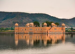 a large building sitting on top of a lake